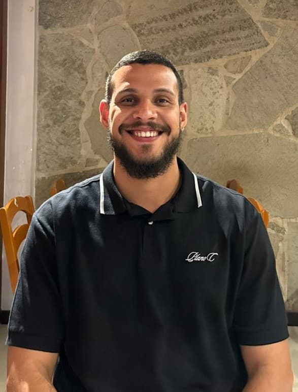 Homem jovem com cabelo curto e loiro, camiseta preta